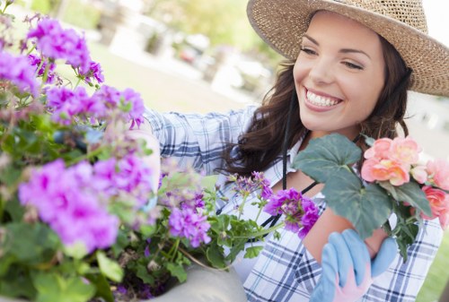 Volunteer tending plants with tactile markers indicating accessible gardening features